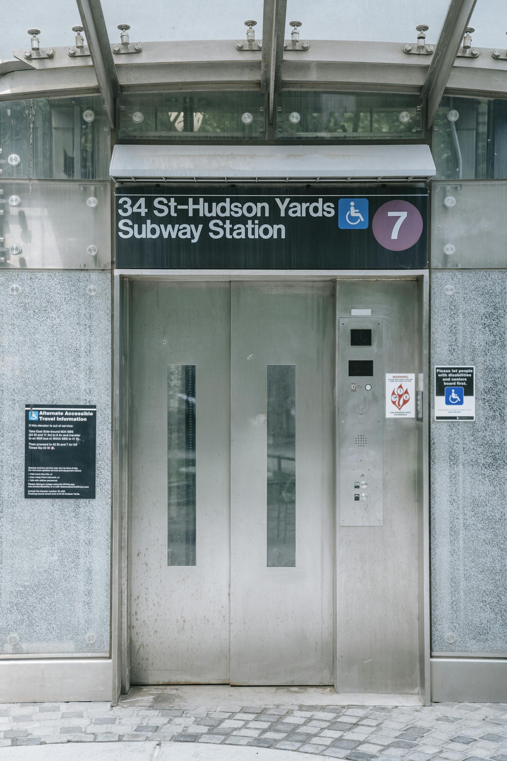 Elevator entrance at 34 St-Hudson Yards Subway Station in NYC, showcasing modern urban transportation architecture.