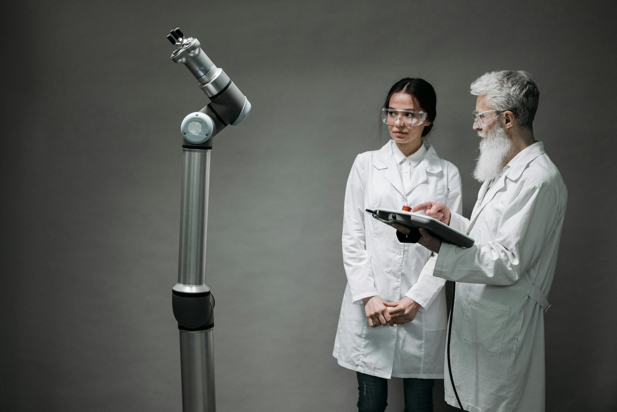 Researchers working with advanced robotics technology in a laboratory setting.