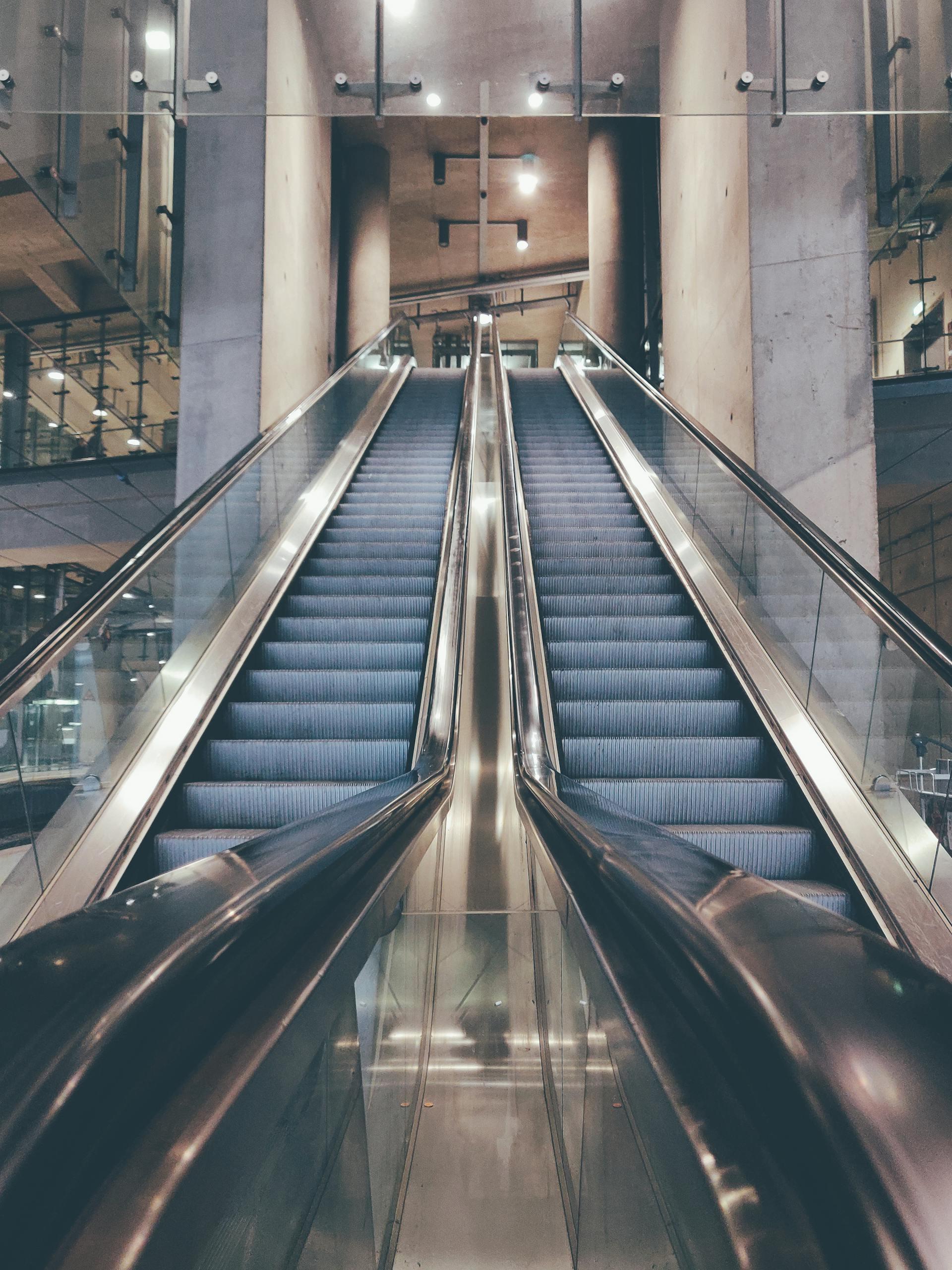 A modern escalator inside a contemporary building with glass architecture in Köln, Germany.